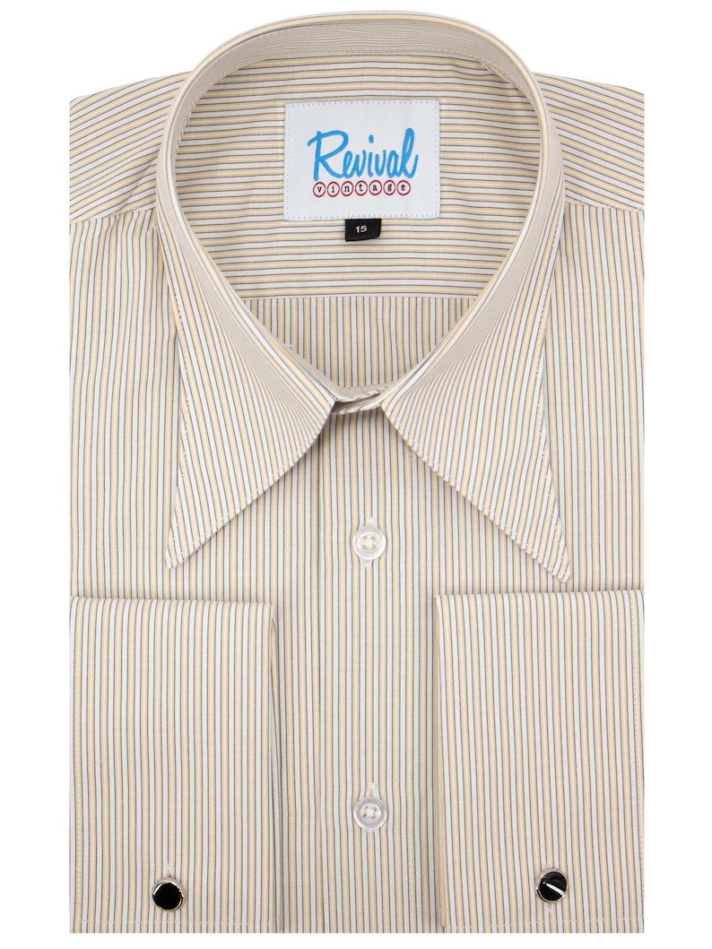 May include: A light beige dress shirt with thin vertical stripes in a darker beige and navy blue. The shirt has a button-down collar, long sleeves with double button cuffs, and a label that reads "Revival Vintage" with a red circle logo.