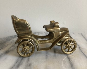 vintage brass car with wheels that roll