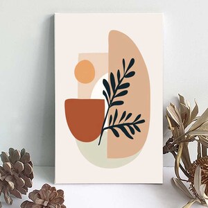 Pode incluir: Impressão de arte abstrata com um esquema de cores pêssego, marrom e verde. A impressão apresenta uma planta estilizada com um sol e formas geométricas.