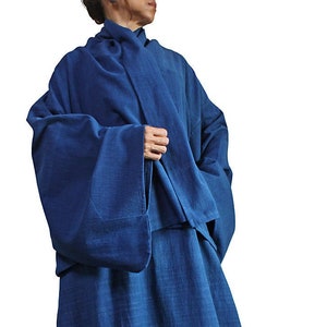 May include: A long, flowing, indigo blue robe with wide sleeves and a simple, loose fit.