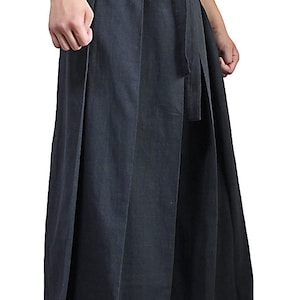 May include: Black wide-leg pants with a tie at the waist.