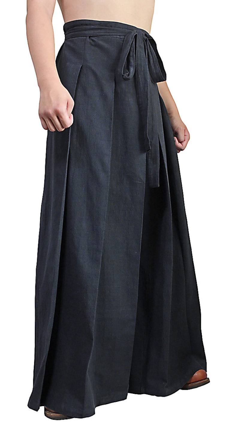 May include: Black wide-leg pants with a tie at the waist.