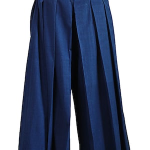 May include: Dark blue wide-leg pants with pleats and a waistband with a tie.