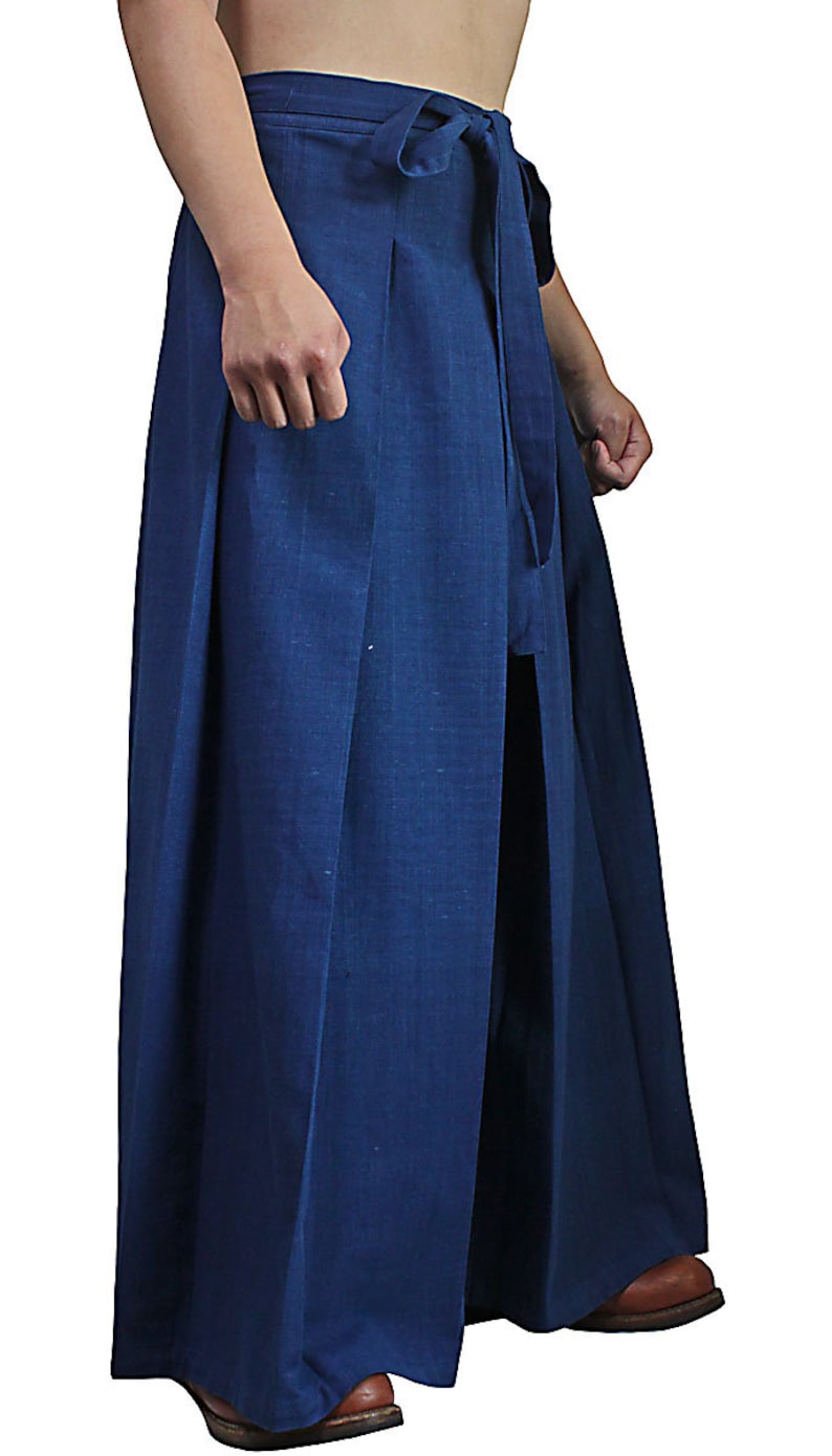 May include: A pair of wide-legged pants with a deep blue color and a tie at the waist.