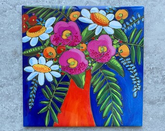 May include: Square canvas art featuring a vibrant floral arrangement in a red vase against a deep blue background. The flowers include pink, white, and orange blooms with green foliage. The artwork has a glossy finish.