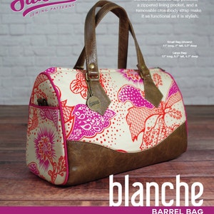 May include: A sewing pattern for a "Blanche Barrel Bag" with a floral print. The bag is brown and pink with a brown leather handle. The pattern is available in two sizes: small (11 inches long, 7 inches tall, 5.5 inches deep) and large (13 inches long, 8.5 inches tall, 6.5 inches deep).