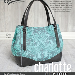 May include: A teal and grey tote bag with a floral pattern and black handles. The bag is 12 inches wide, 11 inches tall, and 6 inches deep. The bag is called "Charlotte City Tote".