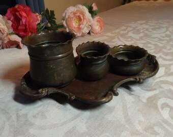 Antique set of copper bowls on a tray. Wavy edge.