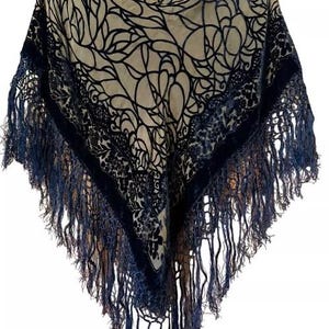 Peut inclure: Un châle en velours noir et beige avec un motif floral et une bordure à franges.