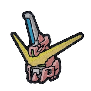 May include: An embroidered patch featuring a pink and yellow cartoon robot head with a blue beam of light coming from the top.