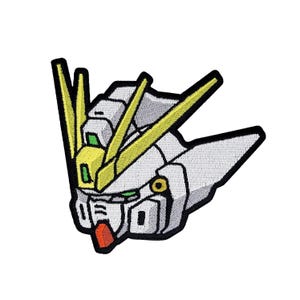 May include: White and yellow embroidered patch of a robot head with a green visor and red mouth.