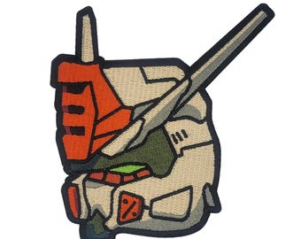May include: Embroidered patch featuring a cartoon-style robot head with a white, gray, and orange color scheme. The robot head has a large, pointed antenna and a single, large eye.