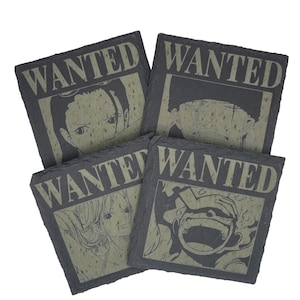 May include: Four square slate coasters with a "WANTED" poster design. Each coaster features a different character illustration in a faded green hue against a dark gray background. The coasters are arranged in a slightly overlapping pattern.