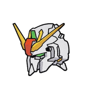 May include: White, yellow, red, and green embroidered patch of a robot head with a single horn.