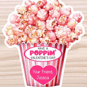 May include: A pink and white popcorn bucket with the text "Have a Poppin' Valentine's Day!" and "Your Friend, Jessica" in a heart shape.