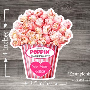 May include: A pink and white popcorn bucket with the text "Have a Poppin' Valentine's Day!" and "Your Friend, Jessica". The bucket is 4 inches tall and 3.5 inches wide.