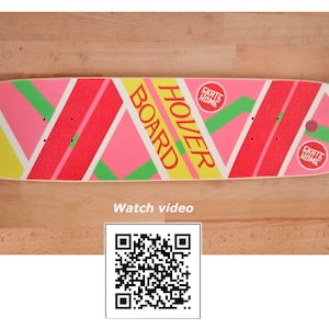 May include: A pink, yellow, and green skateboard with the words "Hover Board" printed on it. The skateboard has two red circles with the words "Skate Home" printed on them.