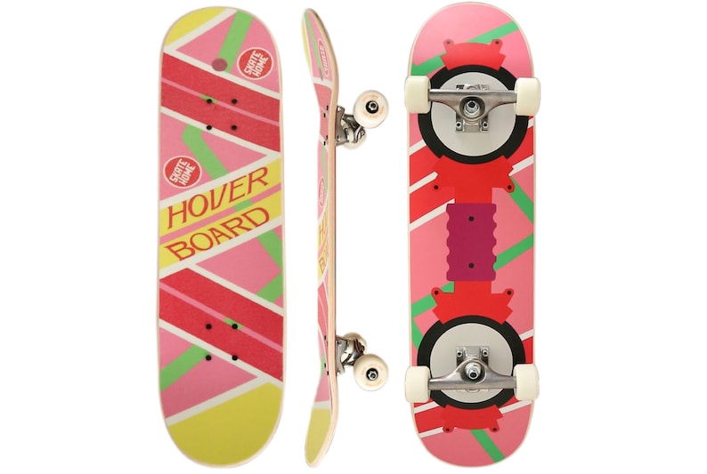 May include: A pink and yellow skateboard with the words "Hover Board" printed on the deck. The skateboard has black wheels and silver trucks. The skateboard is a replica of the hoverboard from the movie Back to the Future.