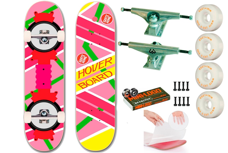 May include: A pink and yellow skateboard with the words "SKATE HOME" and "HOVER BOARD" printed on it. The skateboard comes with trucks, wheels, bearings, and hardware. It also includes a sheet of grip tape.