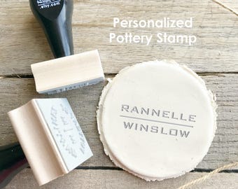 May include: Two black and light wood pottery stamps with the text the PRINT mint .etsy.com on the handle, alongside a circular piece of white clay impressed with the text RANNELLE WINSLOW. The text Personalized Pottery Stamp is visible.