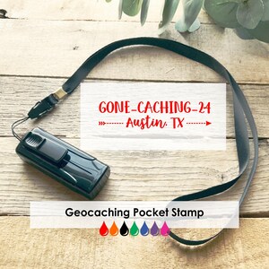May include: A black Geocaching Pocket Stamp with a black lanyard. The stamp has the text "GONE-CACHING-24 Austin, TX" in red. The image also includes a colour palette of orange, black, green, blue, purple, and pink.