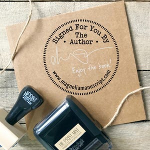 May include: A brown paper package with a circular stamp reading "Signed For You By The Author" and "Enjoy the book!". Two black ink stamps are present, one with "PRINT mint etsy.com" and the other with "THE PRINT MINT theprintmint.etsy.com trodat printy 4912".