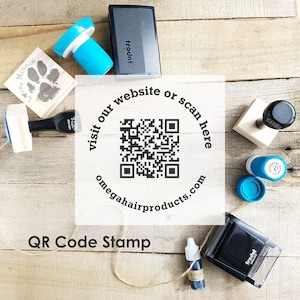 May include: An assortment of stamps and ink bottles on a wooden surface. The image includes a QR code with the text "visit our website or scan here omegahairproducts.com" and "QR Code Stamp". Various stamp designs and colors are visible.