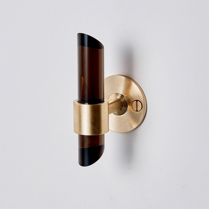 a close up of a door handle on a white wall