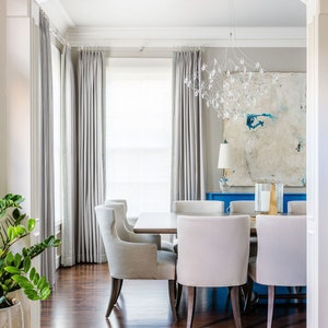 a dining room with a white table and chairs