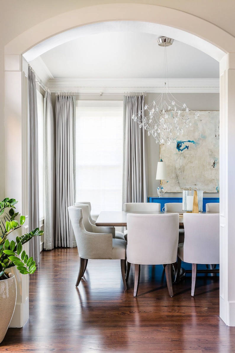 a dining room with a white table and chairs