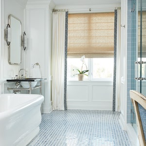 a bathroom with a blue and white tile floor