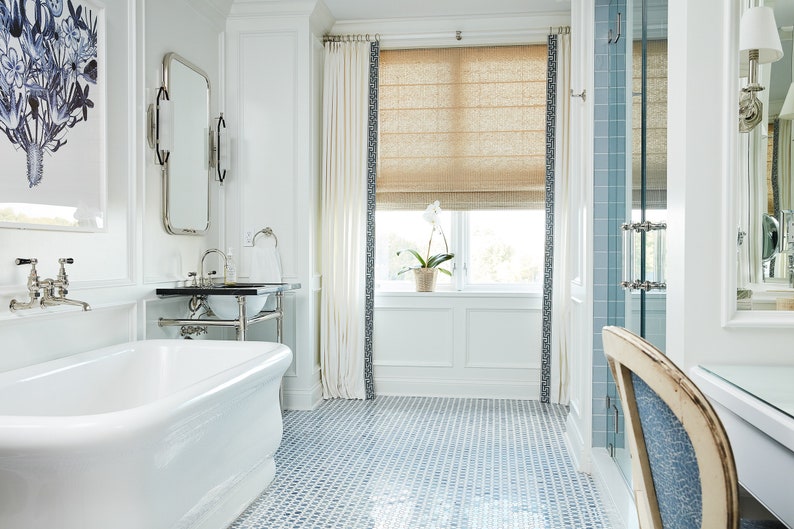 a bathroom with a blue and white tile floor