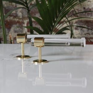 a pair of brass and glass cufflinks on a white surface