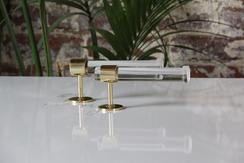 a pair of brass and glass cufflinks on a white surface