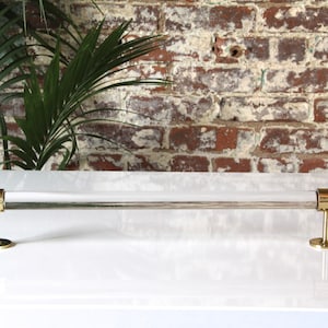 a white counter top with a metal bar on it