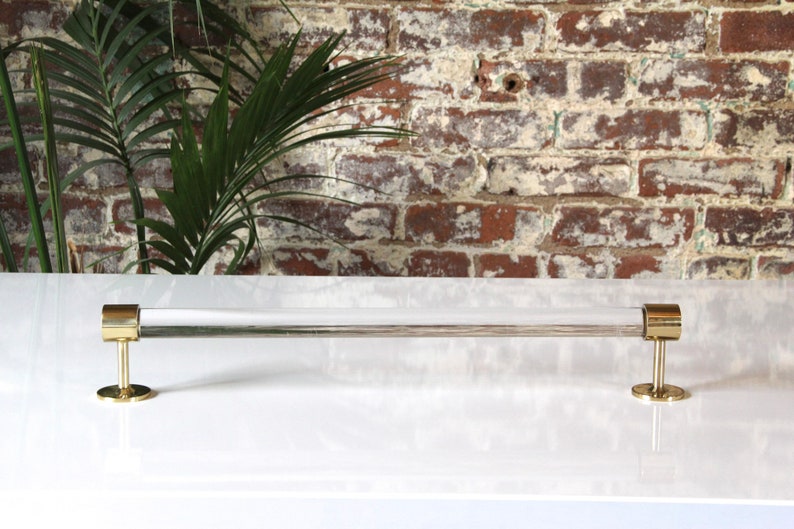 a white counter top with a metal bar on it