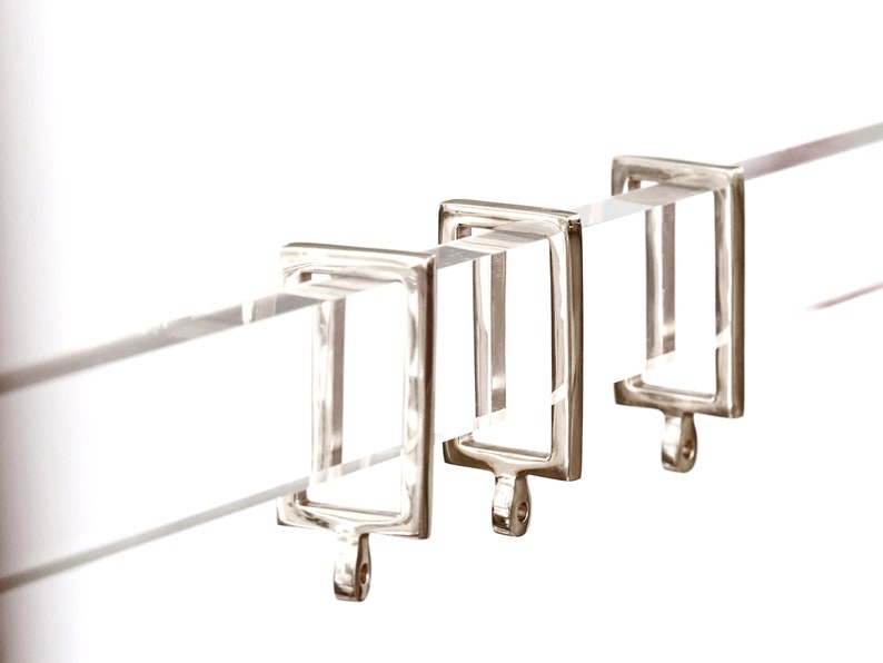 Rectangular curtain rings in polished nickel finish.