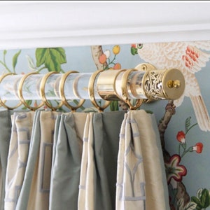 a curtain with a bird on it hanging from a rod