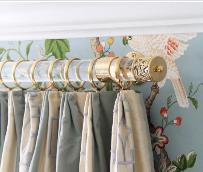 a curtain with a bird on it hanging from a rod