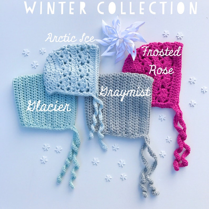 May include: A collection of four crocheted baby bonnets in shades of blue, gray, and pink, with the words "Winter Collection" at the top. The bonnets are labeled "Glacier," "Arctic Ice," "Graymist," and "Frosted Rose."