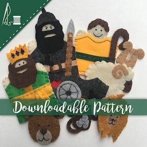 Pode incluir: Um conjunto de fantoches de dedo de feltro que incluem um rei, um cavaleiro, um pastor, uma ovelha, um leão, um urso e um pequeno objeto redondo. Os fantoches são todos coloridos e têm rostos amigáveis. O texto "Padrão para download" é visível na parte inferior da imagem.