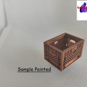 May include: A small, brown, plastic crate, painted in a copper color. The crate is empty and has a grid pattern on the sides. The text "Sample Painted" is visible below the crate.