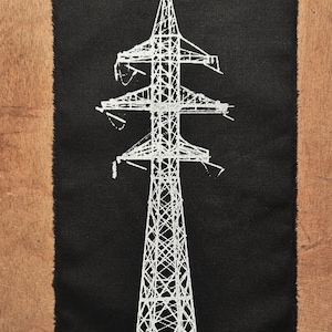 May include: A white embroidered image of a power line tower on a black fabric patch.