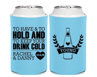 May include: Two light blue foam can coolers featuring black printed text and graphics. One cooler displays the text TO HAVE & TO HOLD AND TO KEEP YOUR DRINK COLD, RACHEL & DANNY, and 12.6.30 in a heart. The other shows a bottle icon and YOUNG.