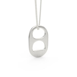 May include: A silver-colored pendant necklace featuring a soda can pull tab design. The pendant is suspended from a delicate silver chain. The necklace is displayed against a white background.
