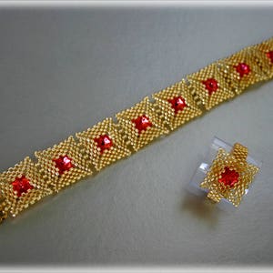 May include: A gold bracelet and ring set with red square-shaped beads. The bracelet is made of small gold beads and the ring is made of gold beads with a red bead in the center.