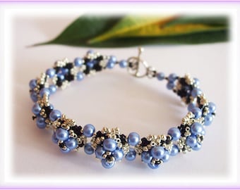 May include: A blue and silver beaded bracelet with a black cord and a silver toggle clasp.