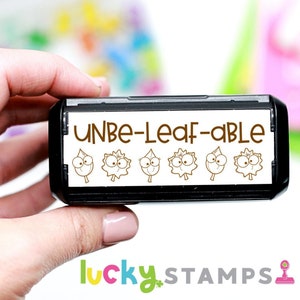 May include: A black and white teacher stamp with the text "UNBE-LEAF-ABLE" and five cartoon leaves with eyes.
