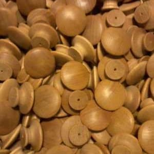 May include: A pile of unfinished wooden knobs with a rounded top and a cylindrical base. The knobs are various sizes and shapes, with a natural wood grain visible. They are likely intended for furniture or craft projects.