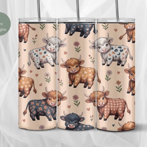 May include: Three stainless steel tumblers with a repeating pattern of cartoon Highland cows in various colors and patterns. The background is a light beige with small floral and heart accents. The tumblers have a silver straw.